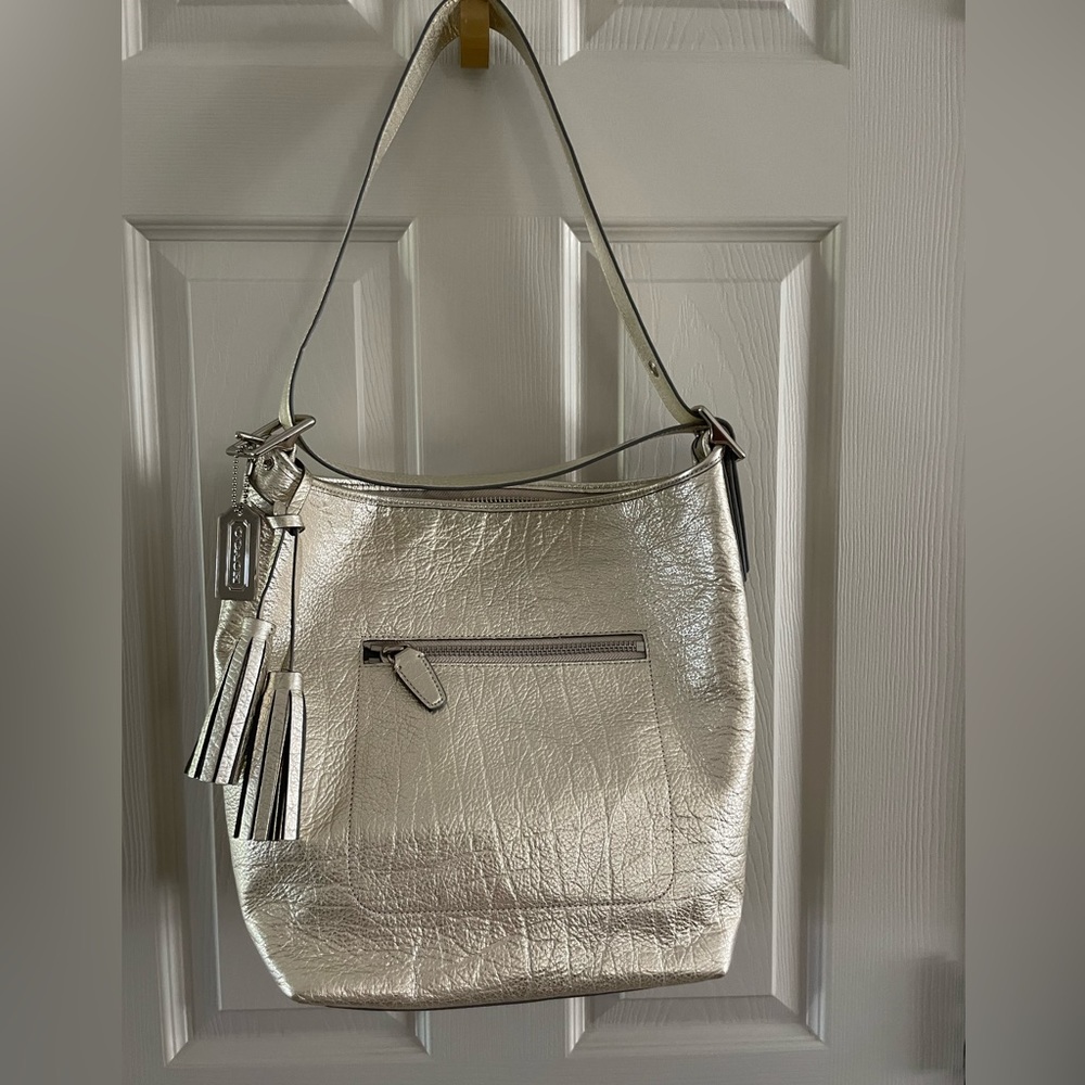 Brand new Coach gold metallic hand bag.